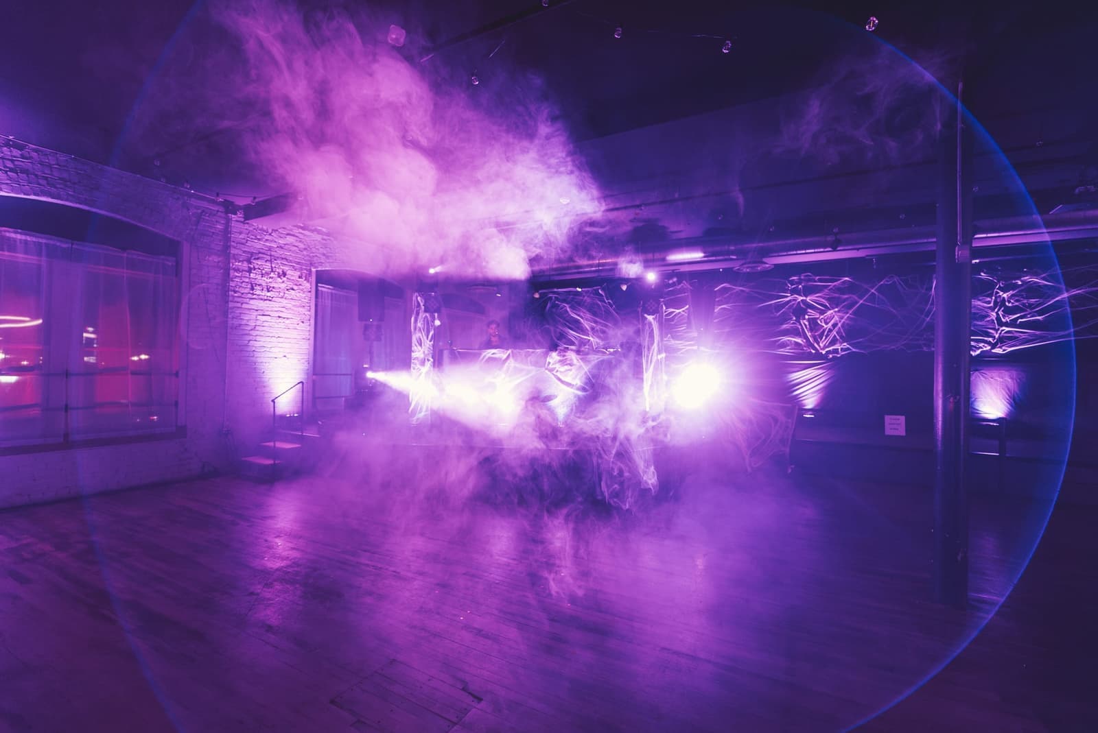 A venue transformed with purple lighting and haze