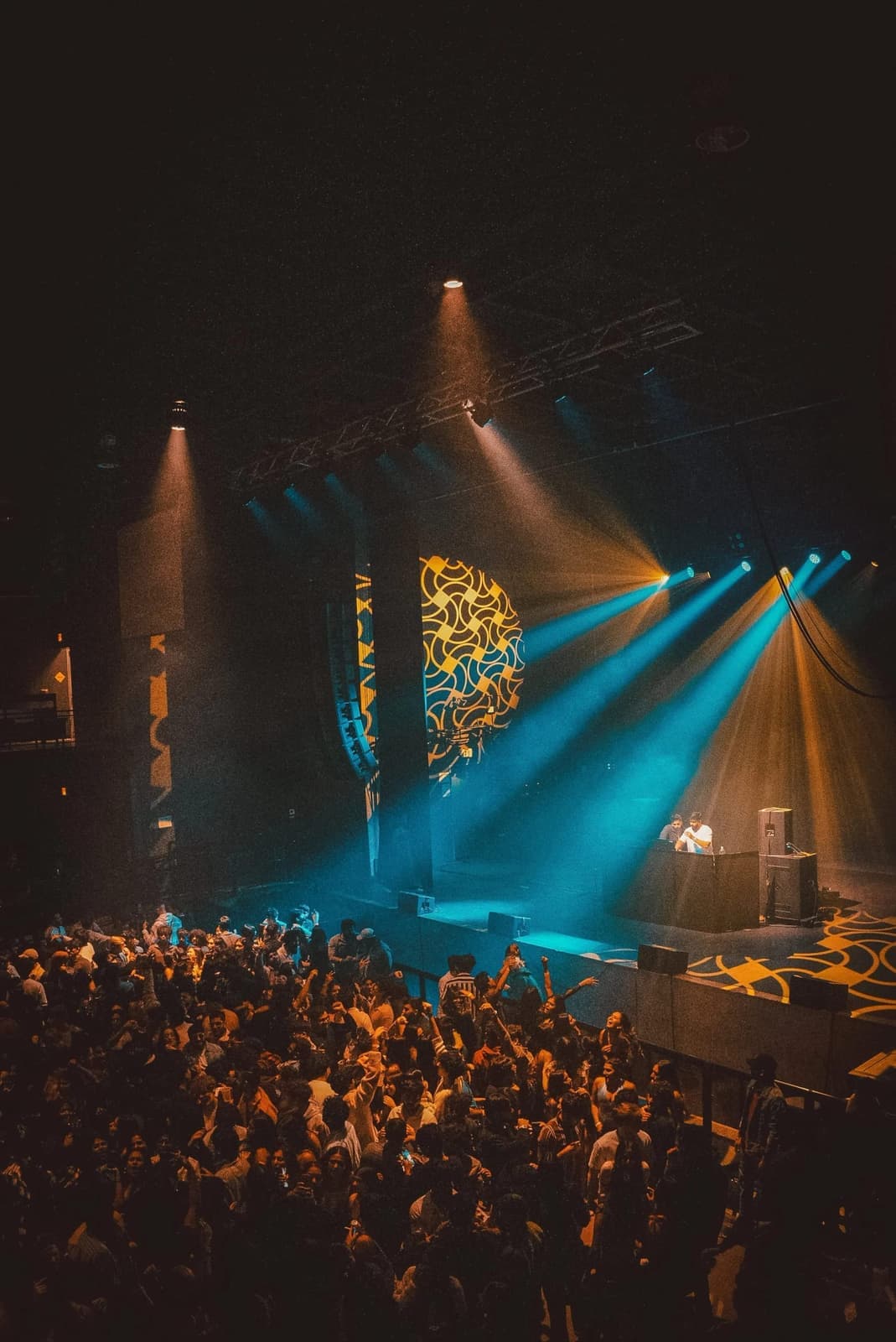 Concert-grade stage lighting rig over a packed college event at an Amped On Campus event