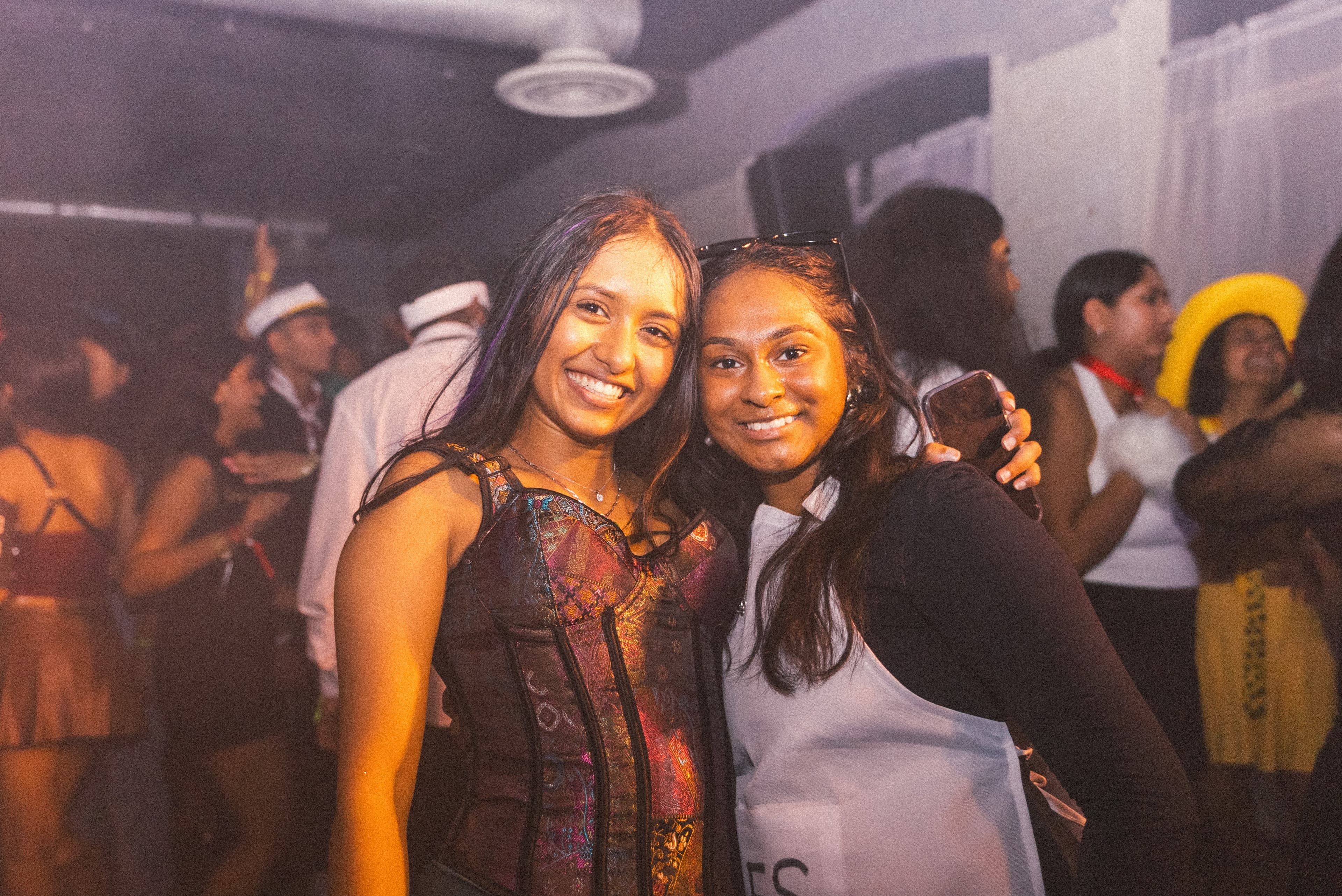 Two friends posing together on the dance floor